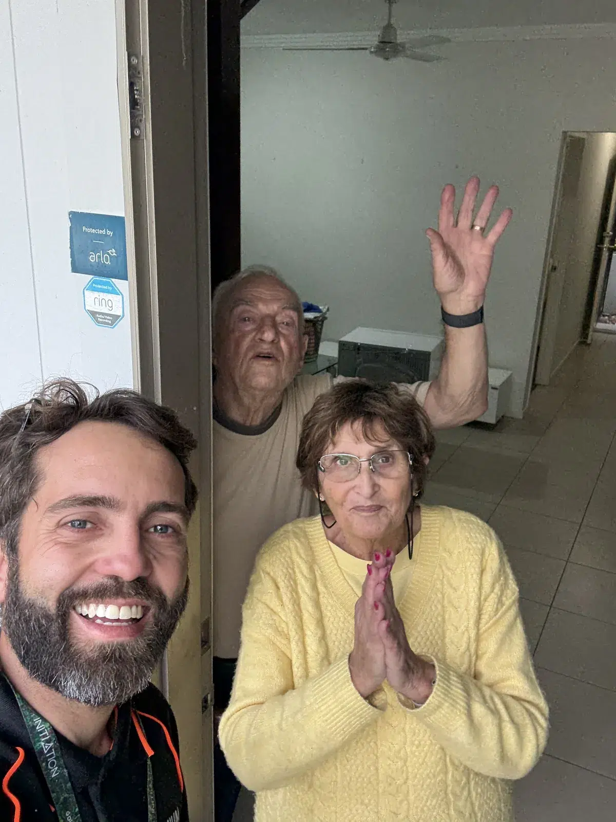 Premium Removals team with happy Gold Coast clients at their front door