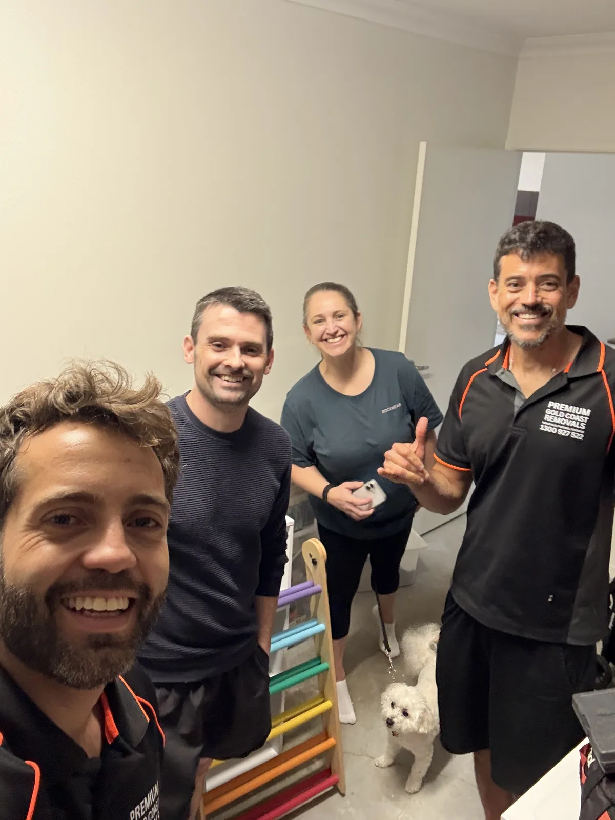 Premium Removals team with satisfied Gold Coast client and dog after a move